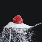 Illustration of sugar crystals attacking tooth enamel