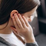 Person Holding Ear