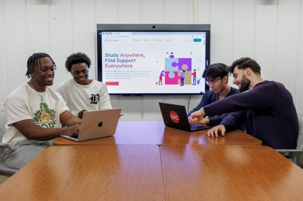 UIC Students Michael Charles, Fawwaz Abayomi, Albert Huynh, and Shpetim Useini working on Akknoledge website, showcasing teamwork and innovation at the University of Illinois at Chicago.