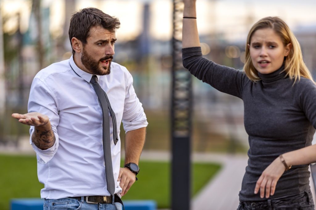 A person actively listening to another, showing empathy and understanding, crucial for de-escalating tense situations.
