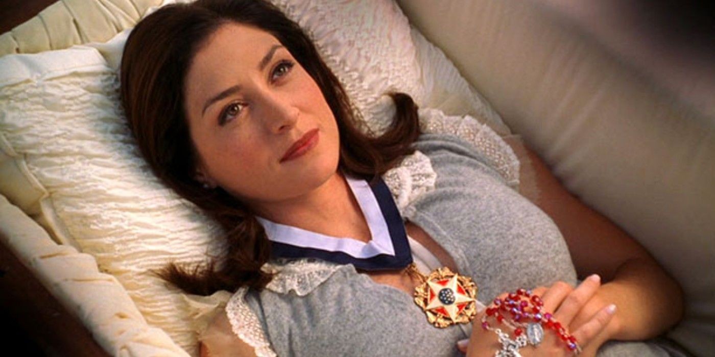 Kate (Sasha Alexander) lying in a casket during her funeral on NCIS, symbolizing the finality of her departure and the impact on the team
