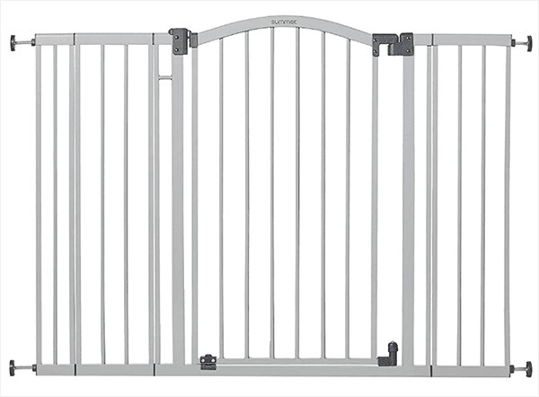 Two separate cats separated by a gate